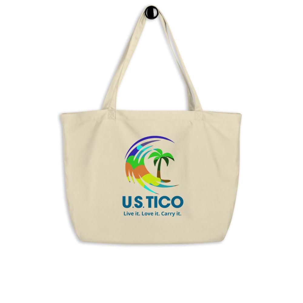 Cream canvas tote bag featuring a colorful tropical wave and palm tree design with U.S.TICO branding.