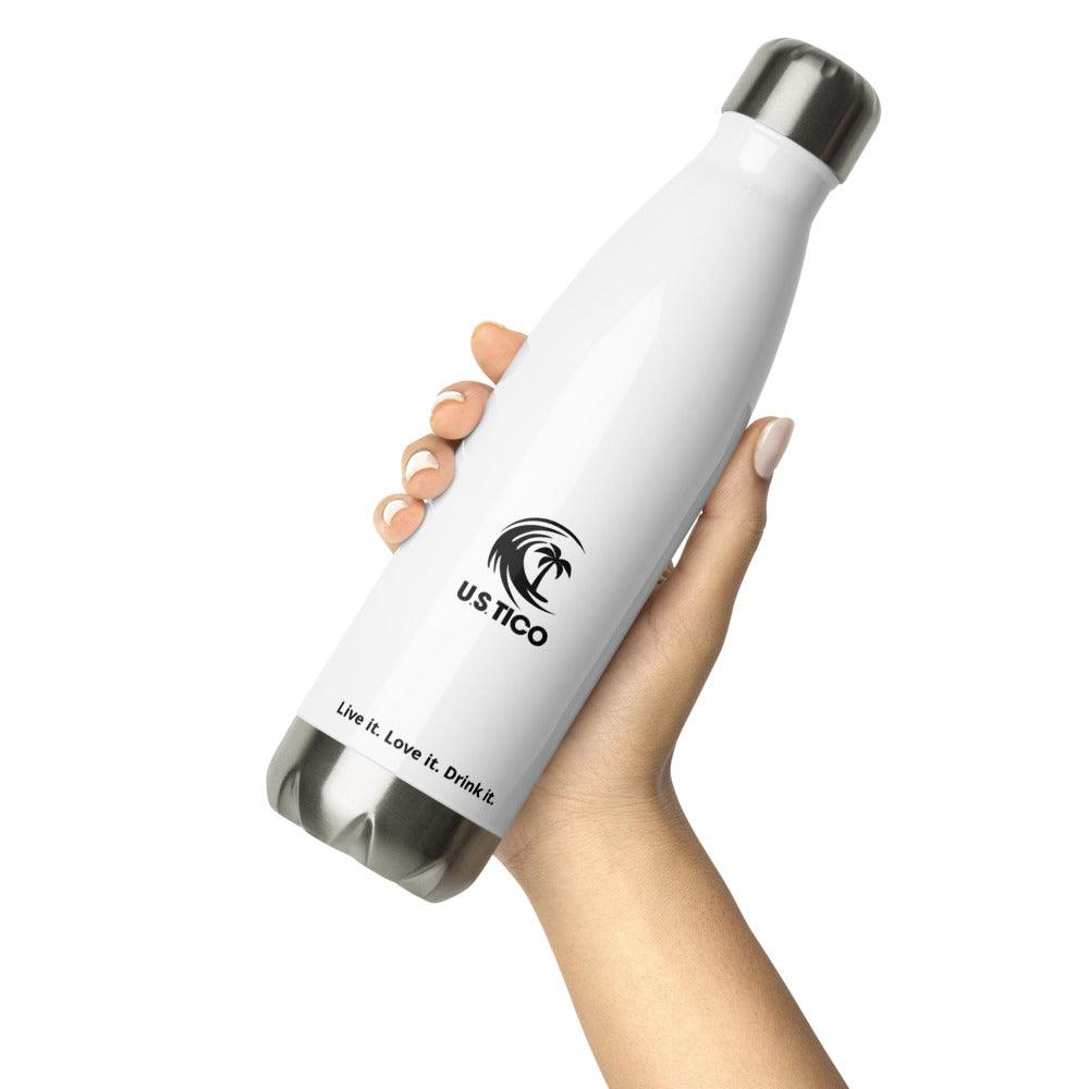 Hand holding a white US Tico insulated water bottle with a palm tree logo