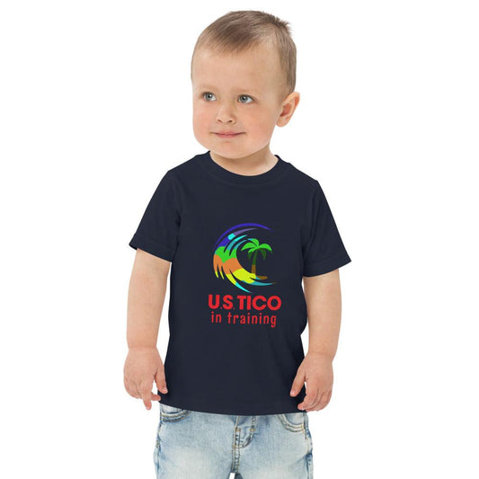 Toddler wearing a navy blue t-shirt with a colorful palm tree logo and 'USTICO in training' text.