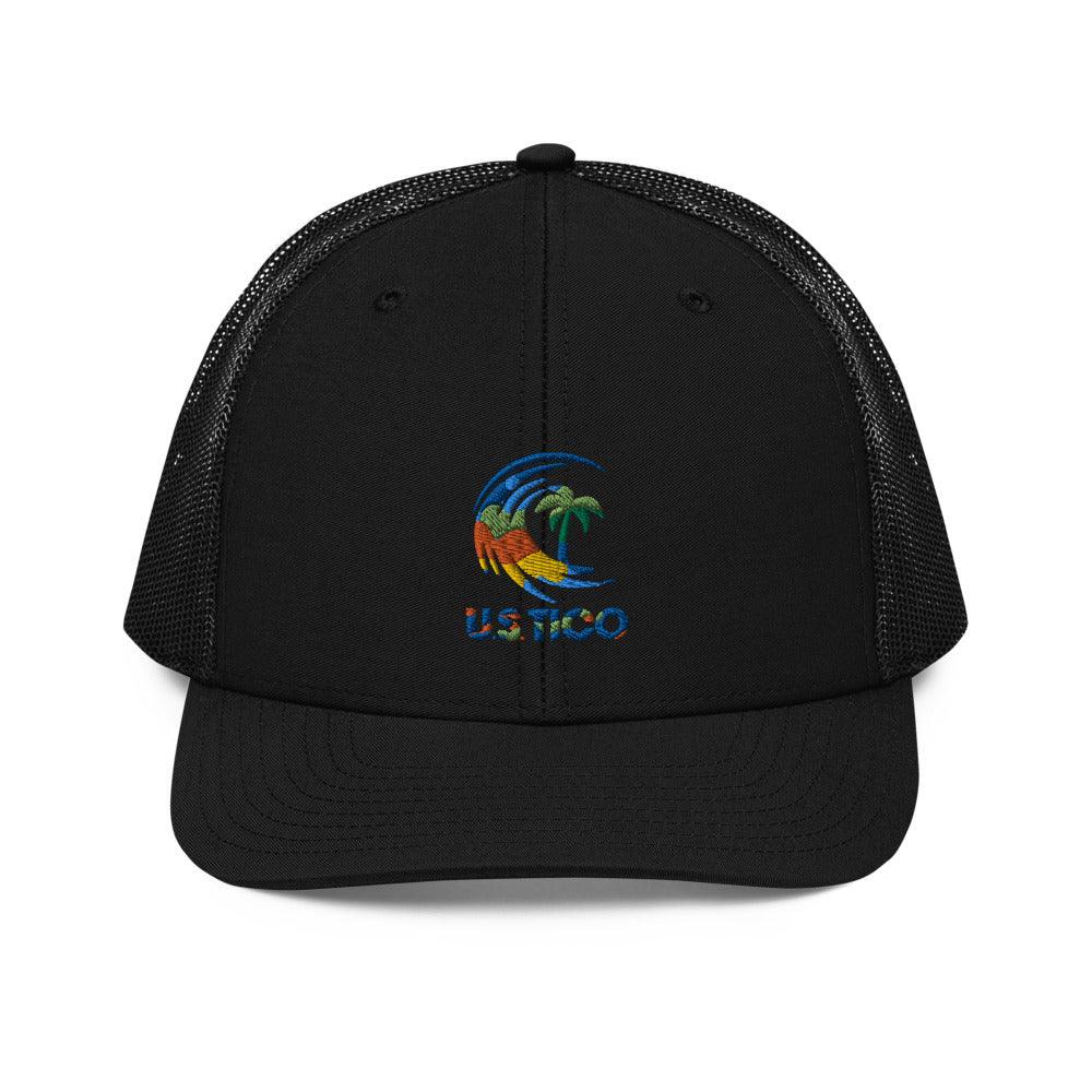 US Tico Colorful Trucker Cap with a black fabric front, mesh back, curved brim, and small multicolor tropical logo
